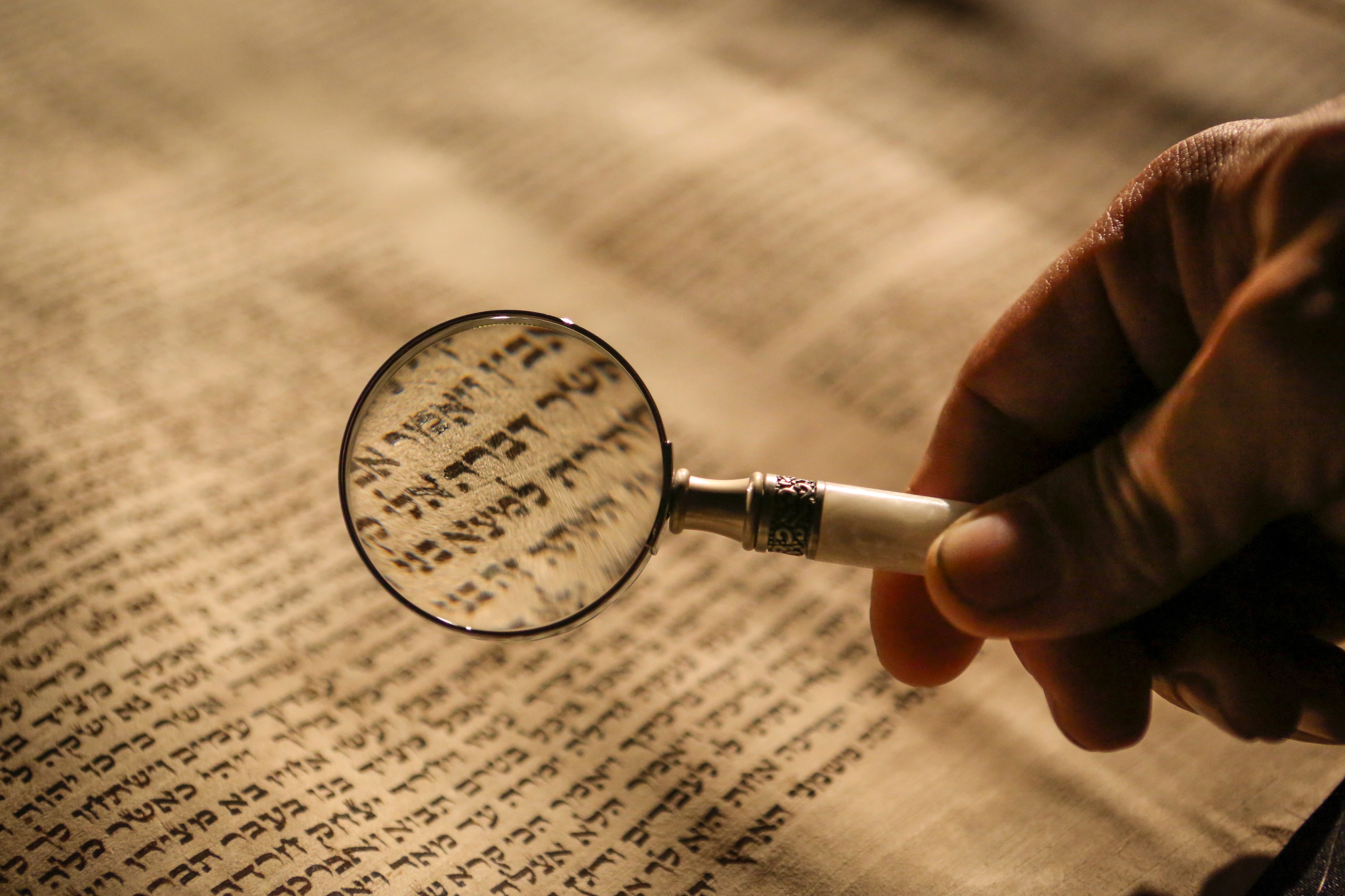 torah scroll with magnifying glass
